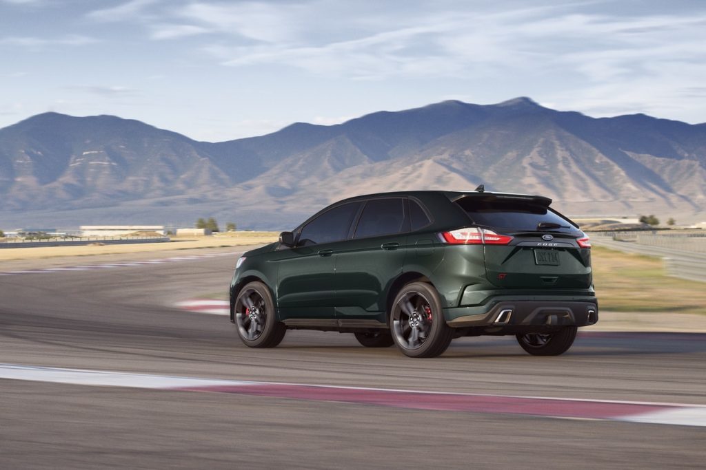 Green 2022 Ford Edge driving down a mountain highway.