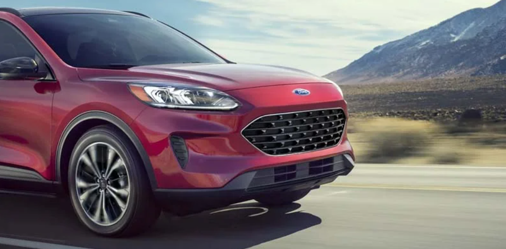 A red 2022 Ford Escape driving on a highway.