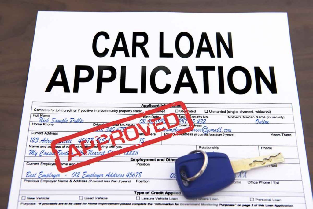 A car loan application form with an "APPROVED" stamp and a car key on top.
