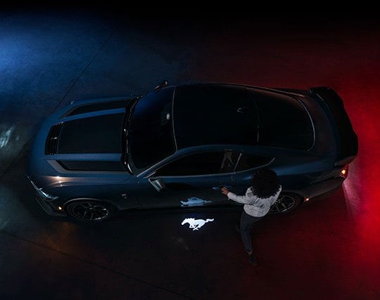 2024 Ford Mustang® Dark Horse™ model with a driver approaching the vehicle | Coughlin Ford of Circleville in Circleville OH